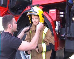 Alex in firefighter's uniform