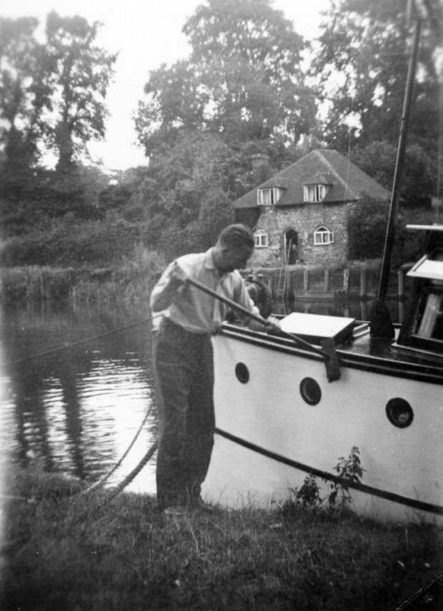 Jack cleaning his boat on the Medway